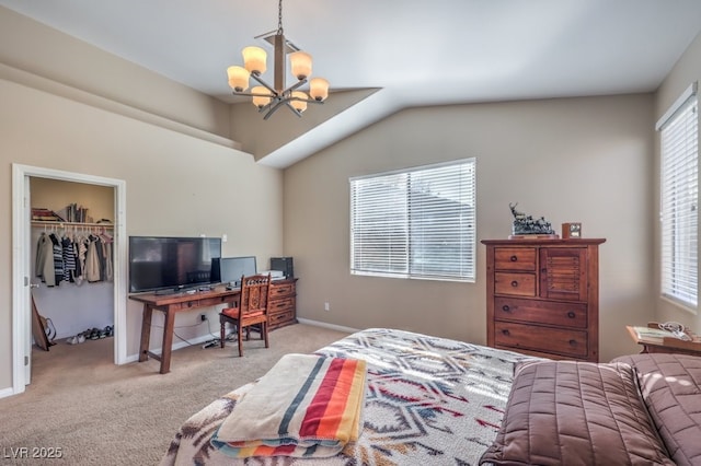 carpeted bedroom featuring vaulted ceiling, a closet, a walk in closet, and an inviting chandelier