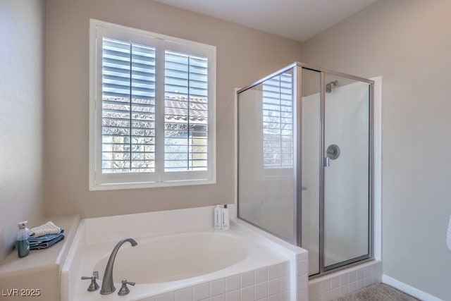 bathroom featuring shower with separate bathtub