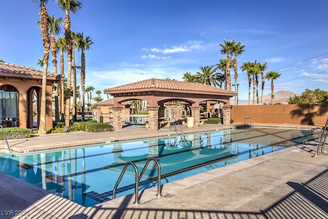 view of pool with a patio area, a gazebo, and a mountain view