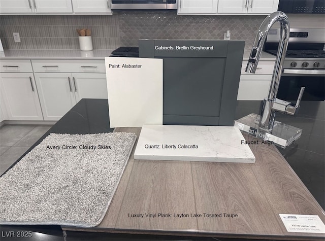 kitchen with decorative backsplash and white cabinetry