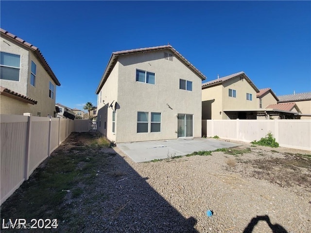 rear view of house with a patio