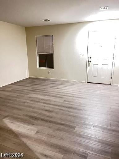 unfurnished room featuring hardwood / wood-style flooring