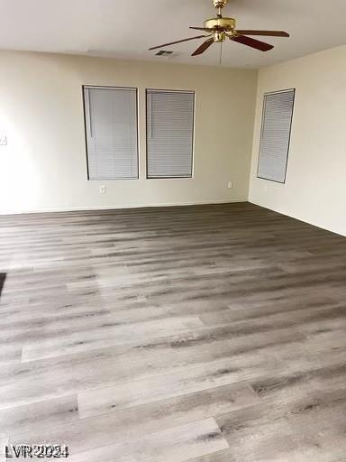 unfurnished room with ceiling fan and wood-type flooring