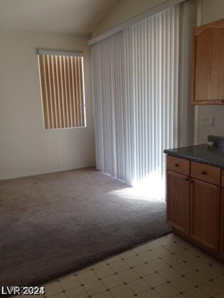 kitchen featuring light colored carpet