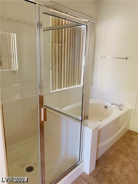 bathroom featuring separate shower and tub