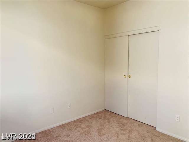 unfurnished bedroom featuring light carpet