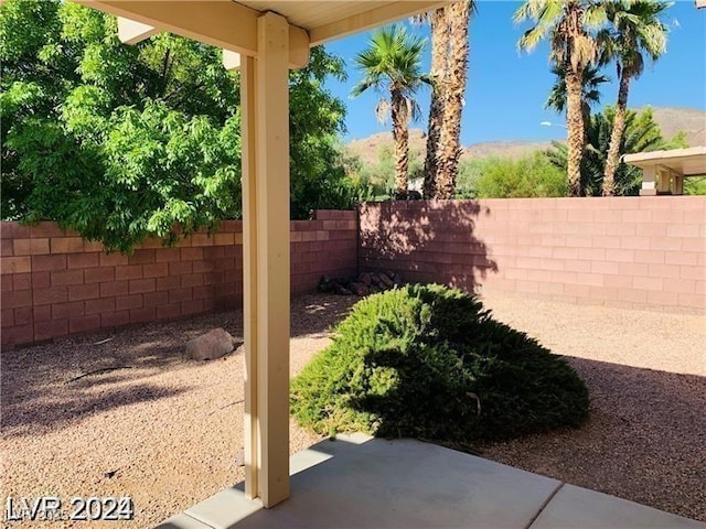 view of yard featuring a mountain view and a patio area