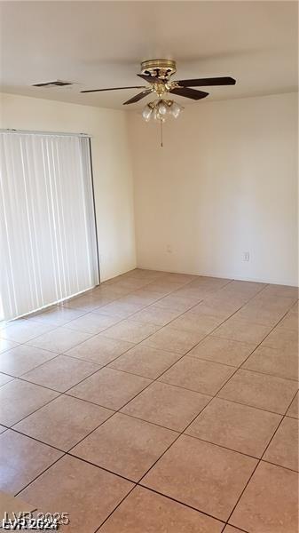 tiled empty room with ceiling fan