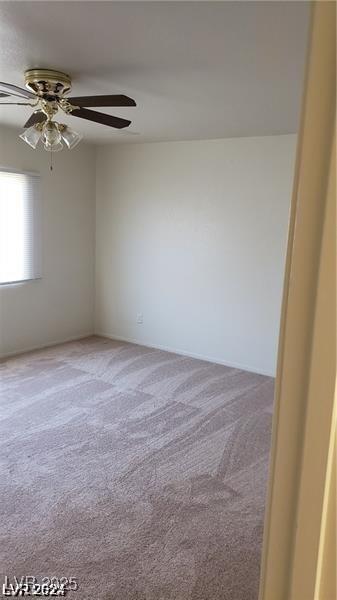 carpeted spare room with ceiling fan