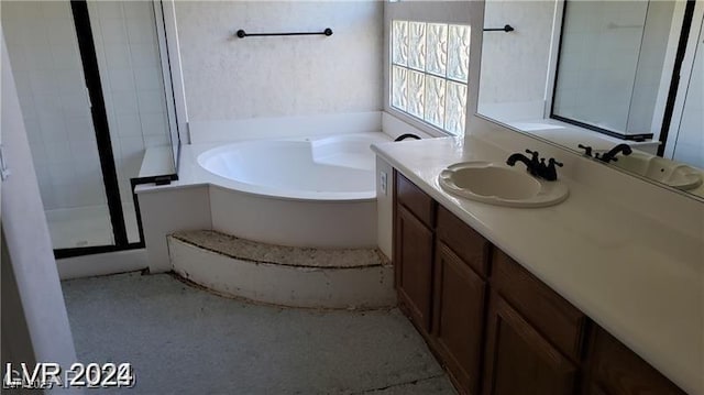 bathroom with vanity and separate shower and tub