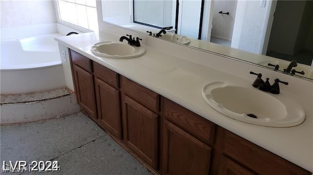 bathroom with vanity and a tub