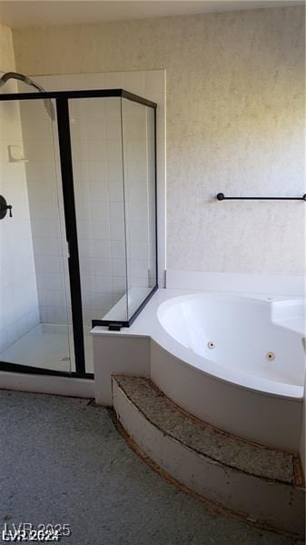 bathroom featuring independent shower and bath