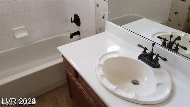 bathroom featuring tile patterned floors, vanity, and tiled shower / bath combo