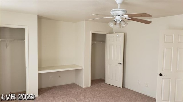 unfurnished bedroom with ceiling fan, a closet, and light carpet