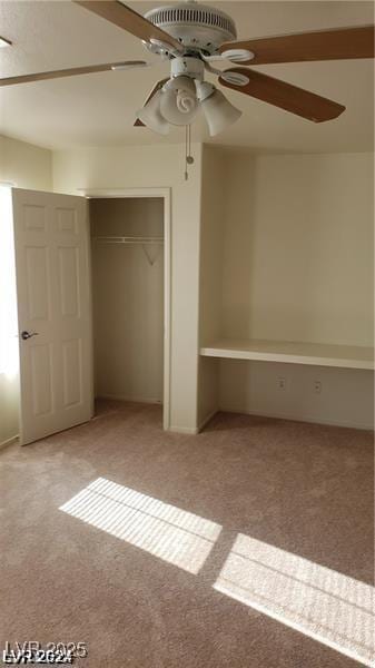 unfurnished bedroom featuring ceiling fan, a closet, and light carpet