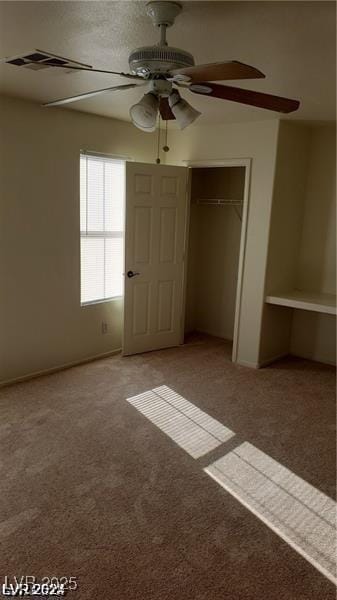 unfurnished bedroom with carpet flooring and ceiling fan