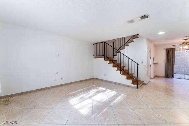 unfurnished room with ceiling fan and light tile patterned floors