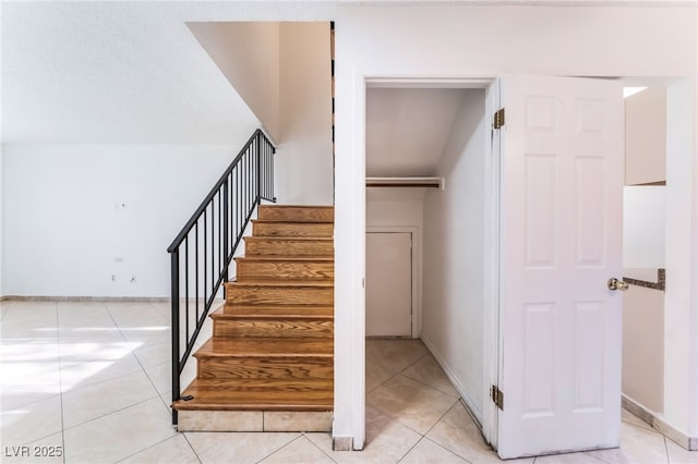 stairs featuring tile patterned flooring