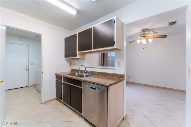 kitchen featuring ceiling fan, sink, stainless steel dishwasher, a textured ceiling, and light tile patterned flooring