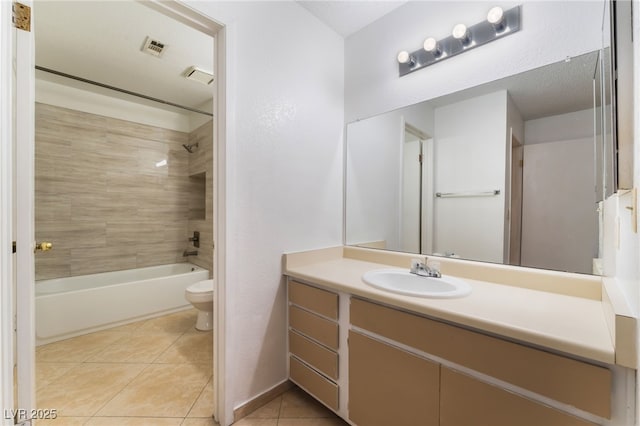 full bathroom with tile patterned flooring, vanity, toilet, and tiled shower / bath