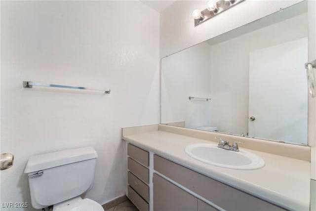 bathroom with tile patterned floors, vanity, and toilet