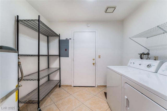 washroom with separate washer and dryer, electric panel, and light tile patterned floors