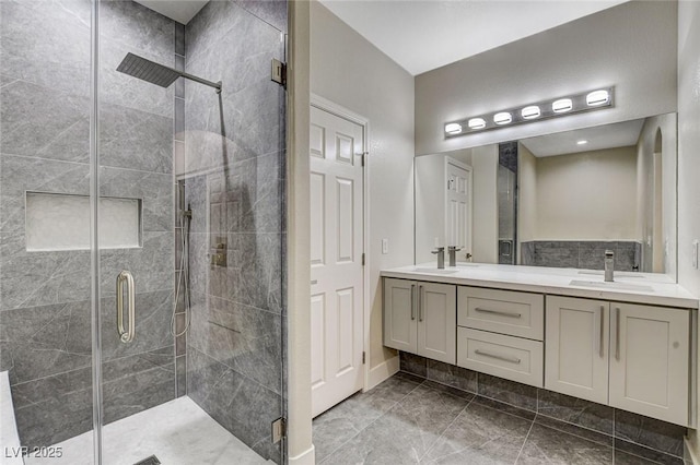 bathroom featuring vanity and an enclosed shower