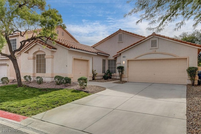 mediterranean / spanish-style house featuring a front yard and a garage