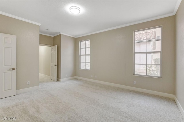 carpeted empty room featuring a healthy amount of sunlight and ornamental molding