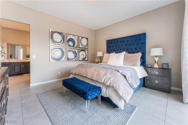 bedroom with light tile patterned flooring and ensuite bath