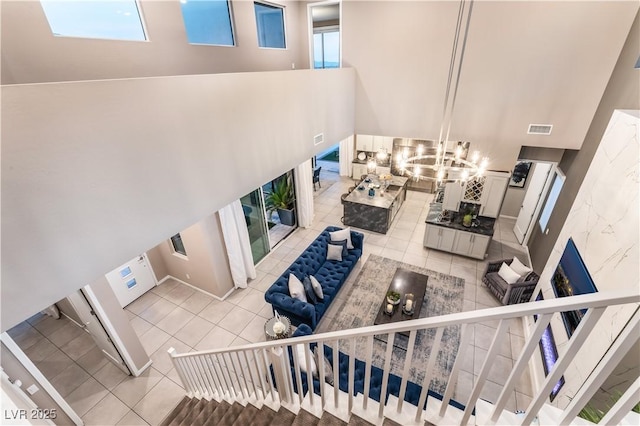 living room featuring light tile patterned floors and a notable chandelier