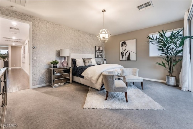 carpeted bedroom with a chandelier