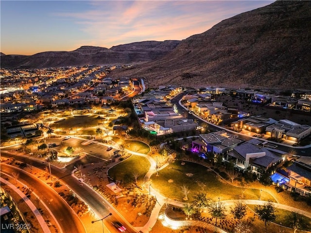 aerial view at dusk featuring a mountain view