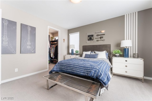 carpeted bedroom featuring a closet and a spacious closet