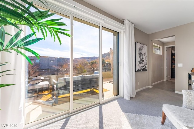 doorway featuring carpet floors and a mountain view