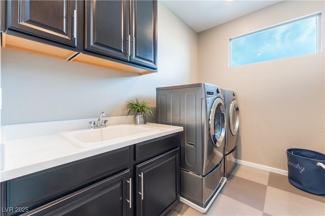 washroom with sink, cabinets, and independent washer and dryer