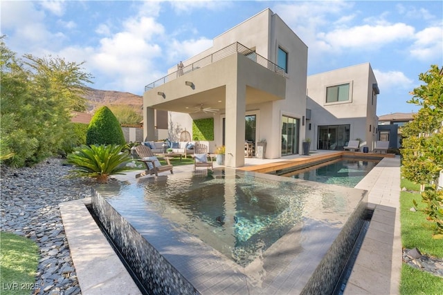 view of swimming pool with an outdoor hangout area, a patio area, and ceiling fan