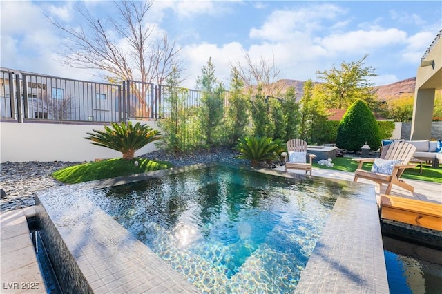 view of swimming pool featuring a jacuzzi and a mountain view