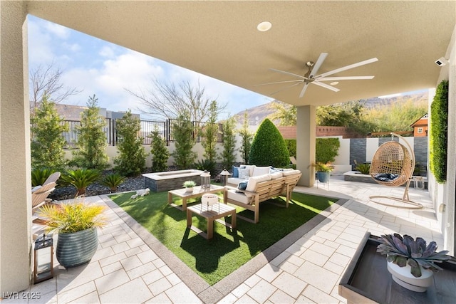 view of patio / terrace with ceiling fan and an outdoor living space