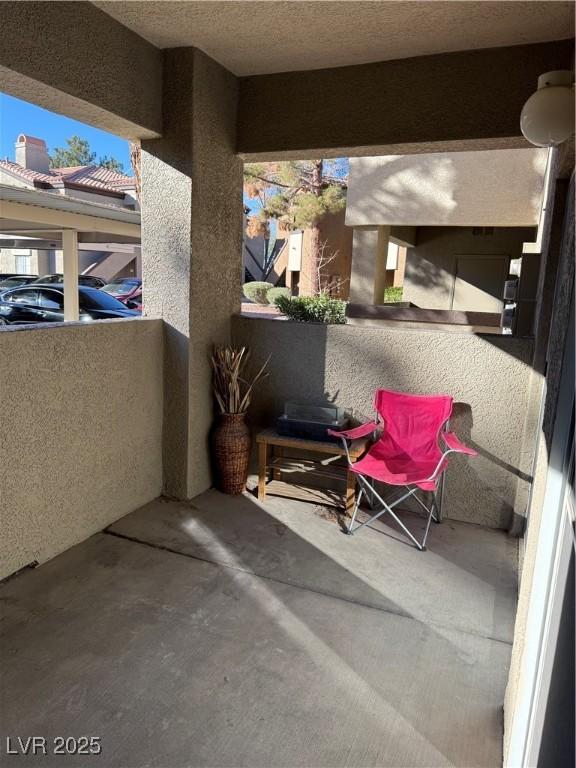 view of patio featuring a balcony