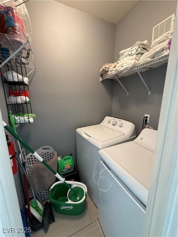 washroom with washing machine and clothes dryer