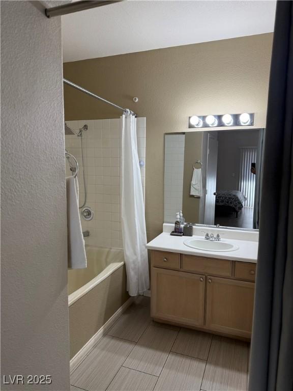 bathroom with shower / tub combo with curtain and vanity