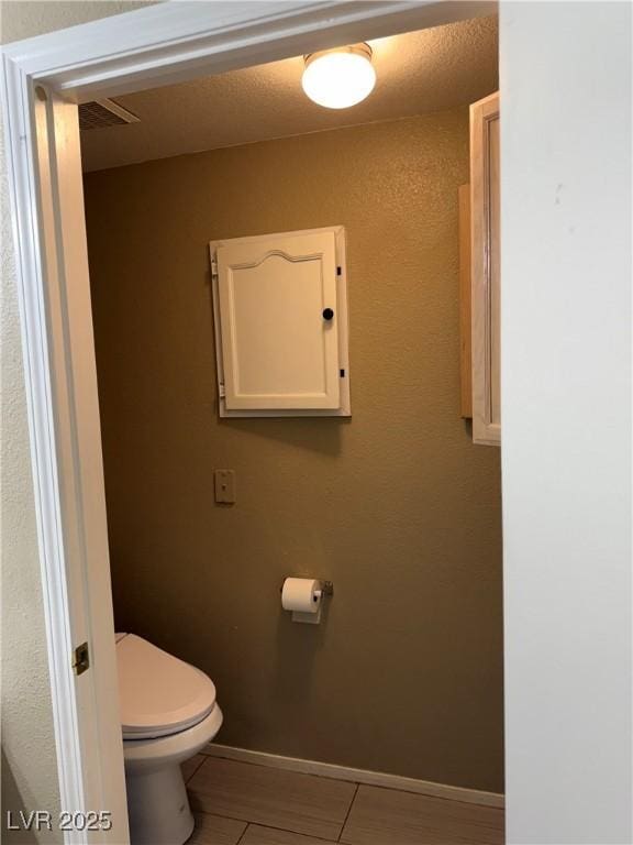 bathroom featuring tile patterned floors and toilet