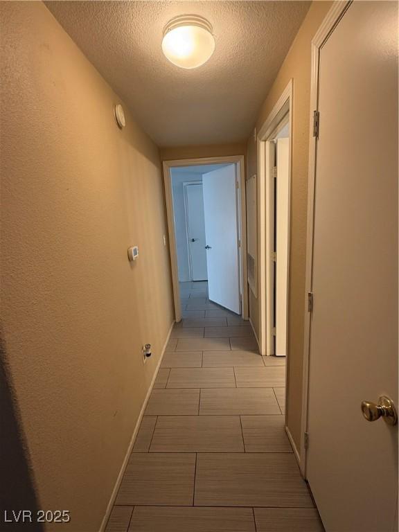 hallway featuring a textured ceiling