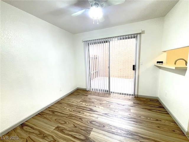 unfurnished room featuring ceiling fan and hardwood / wood-style flooring