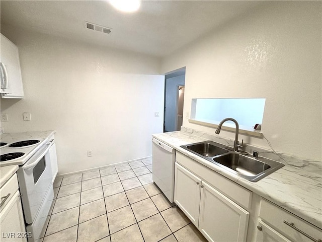 kitchen featuring sink, white cabinets, white appliances, and light tile patterned floors