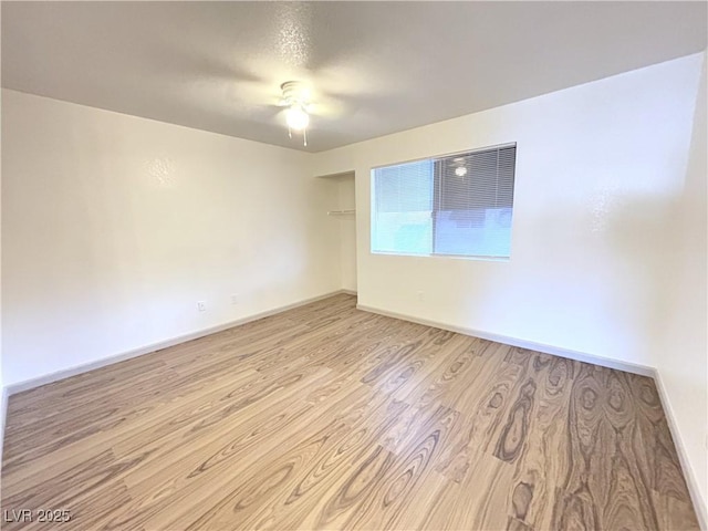 empty room featuring light wood-type flooring and ceiling fan