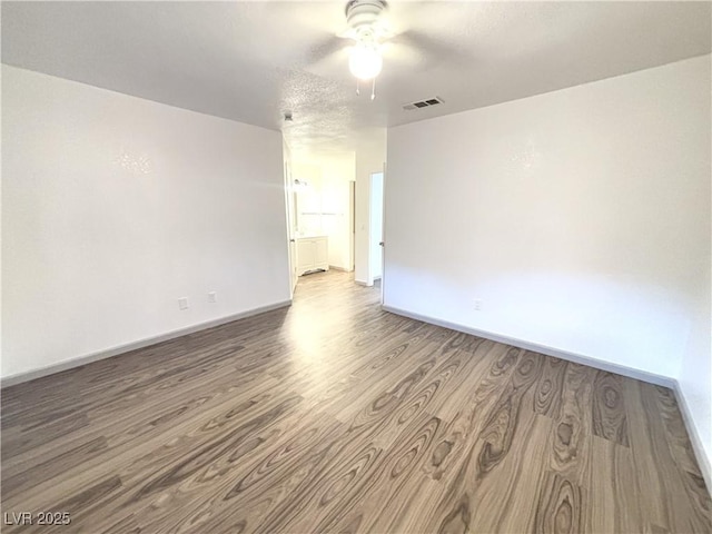 spare room with ceiling fan and hardwood / wood-style floors