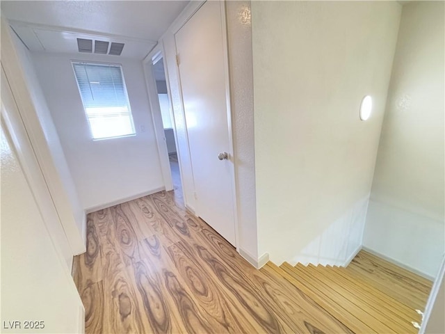 hallway with light hardwood / wood-style flooring