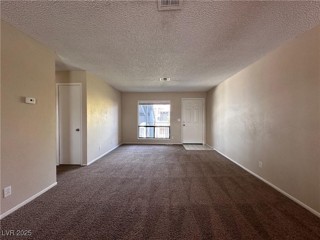 empty room featuring carpet floors and a textured ceiling